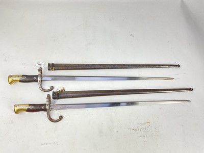 Lot 880 - Two French 1874 pattern Gras bayonets with scabbards (2).