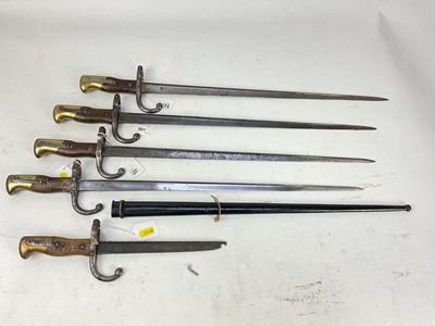 Lot 881 - French 1874 pattern Gras bayonet in scabbard, together with three other Gras bayonets without scabbards and one other cut down Gras bayonet (5).