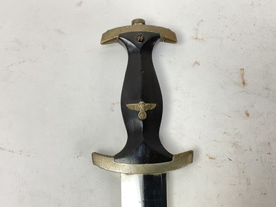 Lot 875 - Scarce Nazi SS model 1933 dress dagger, with ebonised wood grip and nickel plated fittings - the crossguard marked with 'I', the blade etched 'Meine Ehre heist True' and Rich Herder Solingen, retai...