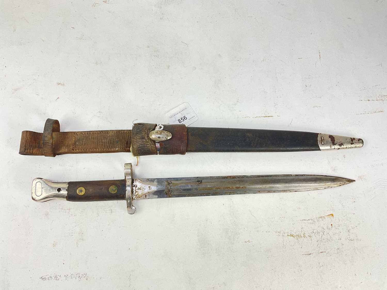 Lot 856 - Boer War era British Lee Metford 1888 pattern bayonet in leather scabbard with plated metal mounts, and leather frog.