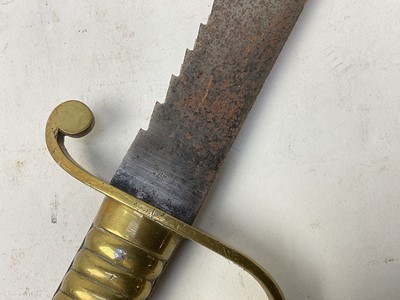 Lot 850 - British 1856 pattern Pioneers short sword with ribbed brass stirrup hilt and steel sawback blade, no scabbard present.