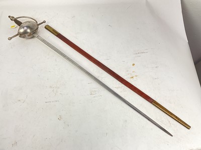 Lot 832 - 19th century Spanish rapier with brass hilt, turned ebony grip and etched tapered blade decorated with trophies and indistintly named in leather sheath and another theatrical rapier in sheath (2)