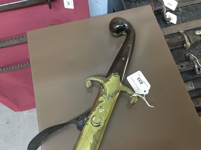 Lot 833 - 19th century Turkish Officer's sword with horn grips, brass crossguard, curved fullered blade in brass mounted leather sheath with crescent and star badge to the chape.