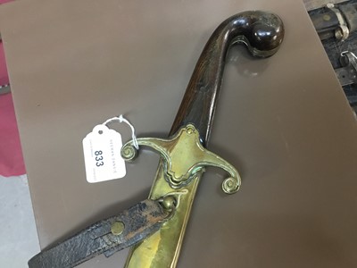 Lot 833 - 19th century Turkish Officer's sword with horn grips, brass crossguard, curved fullered blade in brass mounted leather sheath with crescent and star badge to the chape.