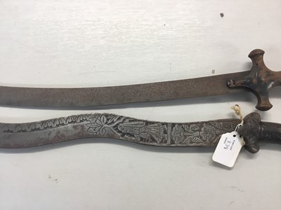 Lot 838 - 19th century Indian Tulwar with steel hilt and curved blade and old Indian dagger with waved blade decorated with figures and flowers (2)