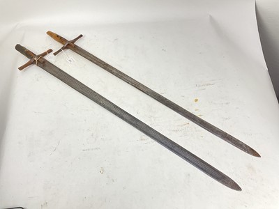 Lot 841 - Two 19th century Sudanese broad swords with cruciform hilts, one decorated with Islamic script, the other with long fullers and armorers marks, 101-103cm