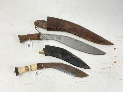 Lot 896 - Gurkha Kukri with two piece wooden grip and curved steel blade stamped with crescent moon in leather covered sheath, blade 33.5cm, together with another similar Kukri with bone grip, blade 21cm in...