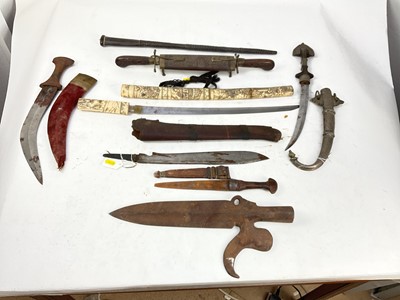 Lot 897 - Group of Eastern daggers and knives together with a fencing foil and a small leather covered baton (9)