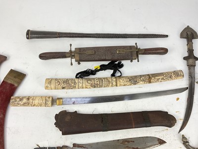 Lot 897 - Group of Eastern daggers and knives together with a fencing foil and a small leather covered baton (9)