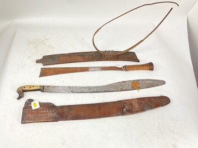 Lot 842 - 19th century Burmese Kachin Dao sword with rattan bound grip, broad hatchet tip blade in original wood sheath with rattan bindings and belt and an old machete with sheath (2)