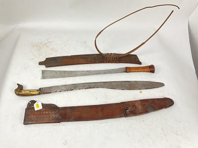 Lot 842 - 19th century Burmese Kachin Dao sword with rattan bound grip, broad hatchet tip blade in original wood sheath with rattan bindings and belt and an old machete with sheath (2)