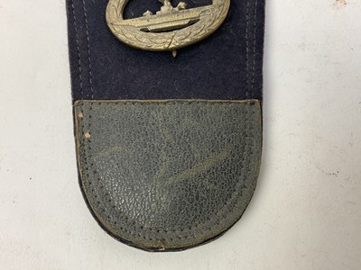 Lot 874 - Scarce Second World War Nazi Kreigsmarine blue cloth dress dagger pouch, with leather chape and castellated top with draw string fastening, the pouch decorated with various and insignia to include...