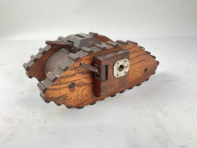 Lot 798 - Scratch built wooden money box in the form of a First World War British tank, 24.5cm in length.