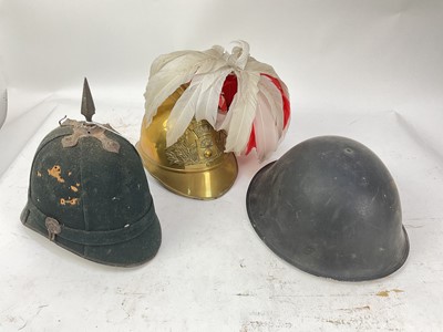 Lot 792 - Late Victorian blue cloth helmet, no regimental badge present, together with a French brass Fire Brigade helmet and a British MKIV steel helmet dated 1953 (3).