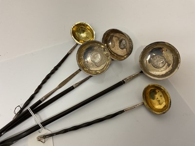 Lot 51 - Group of five Georgian silver toddy ladles with whalebone handles, to include a pair (London 1802) and three other unmarked examples set with coins, (5).