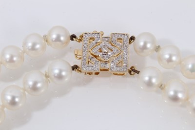 Lot 426 - Cultured pearl two-strand opera length necklace with a 14ct gold and diamond clasp