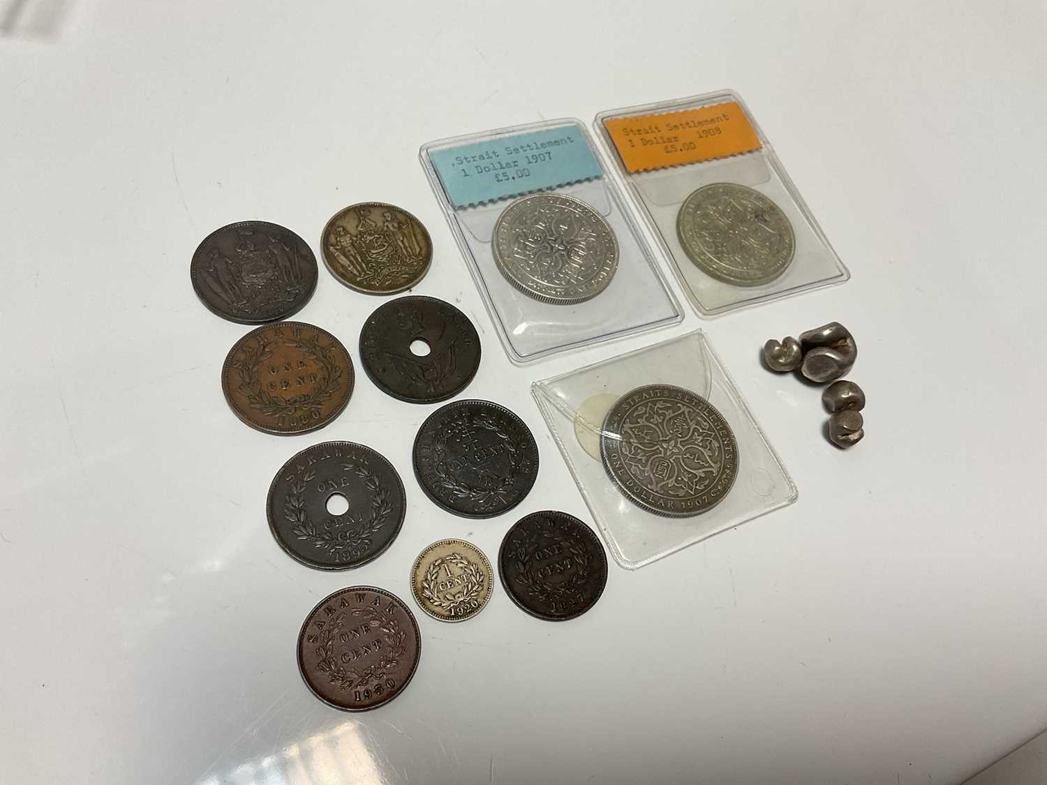 Lot 71 - World - Mixed coins to include Siam Rama IV Silver Bullet Money x 4, Straits Settlements Silver Dollars 1907 x 2 AVF & AEF, 1908 GVF and nine other North Borneo & Sarawak coins (16 coins)