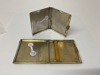 Lot 13 - George V silver cigarette case of square form with engine turned decoration and gilded interior, (London 1922), maker C&W Padgett, 8.3cm in overall length, together with another similar silver ciga...