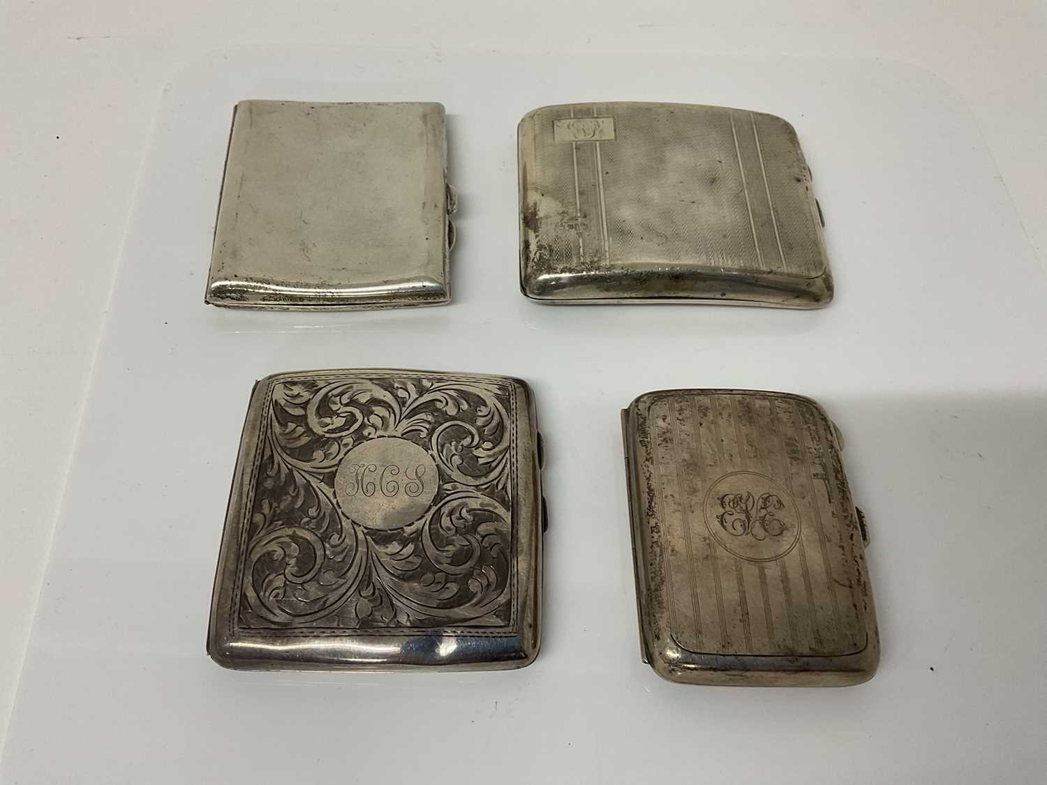 Lot 19 - George V silver cigarette case of rectangular form, (Birmingham 1916), maker Jones & Crompton, 8.5cm in overall length, together with three another similar silver cigarette case (Birmingham 1922, 1...
