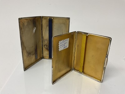 Lot 22 - George V silver cigarette case of rectangular form with engine turned decoration and gilded interior, (Birmingham 1921), 14.2cm in overall length, together with another similar silver cigarette cas...