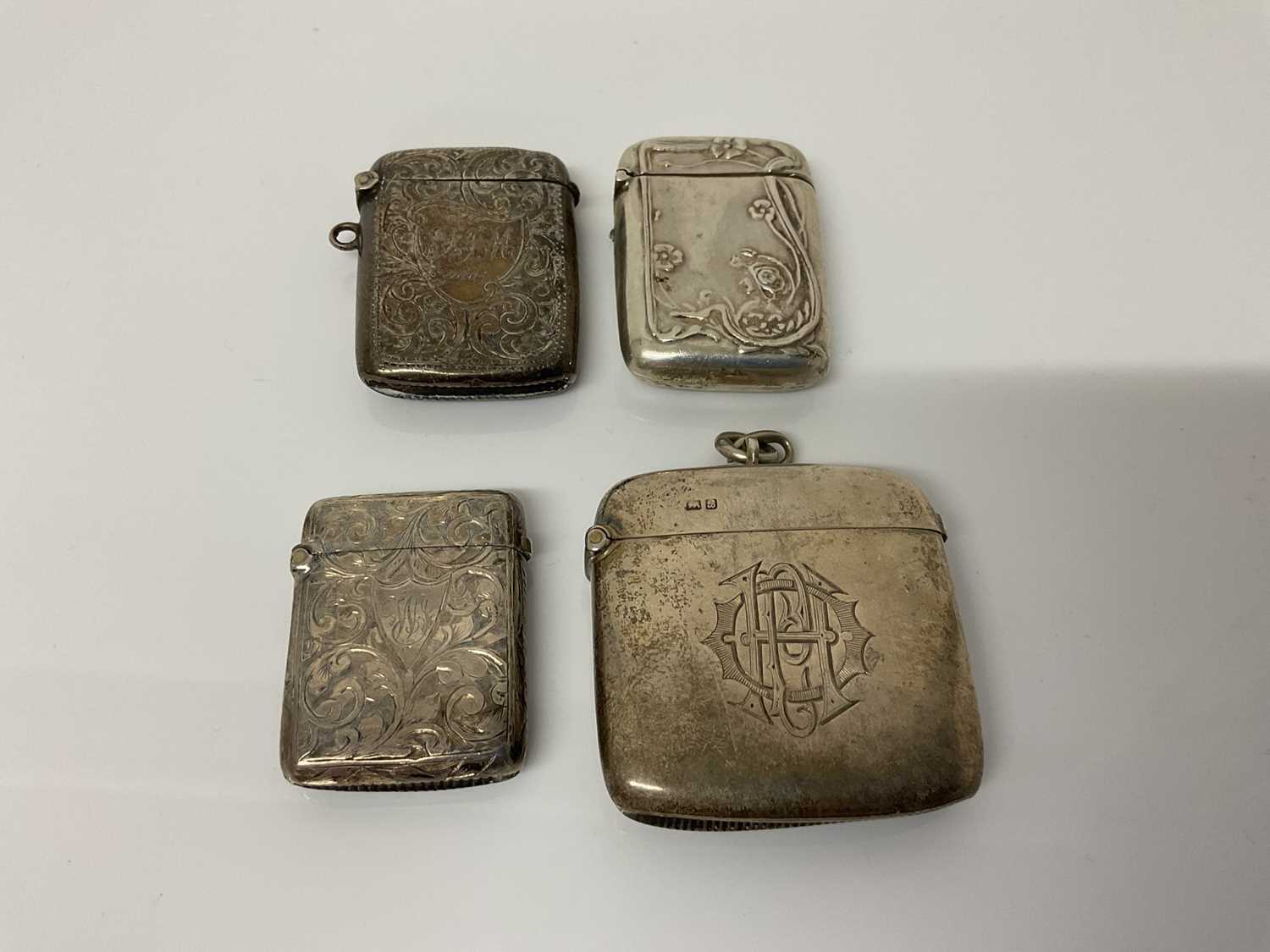 Lot 43 - Victorian silver vesta case with engraved decoration, (Birmingham 1900), together with three other silver Vesta cases (Birmingham 1904, Chester 1902 and another marked Sterling), all at 3.5ozs (4)