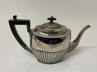 Lot 57 - George V silver teapot with fluted decoration and ebonised handle and finial, (Sheffield 1910), maker Atkin Brother, 27cm in overall length, 17.6ozs