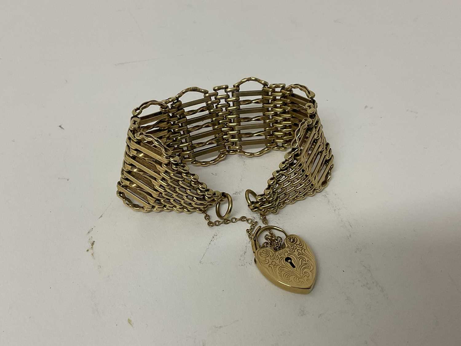 Lot 96 - 9ct yellow gold gate bracelet with heart shaped padlock clasp