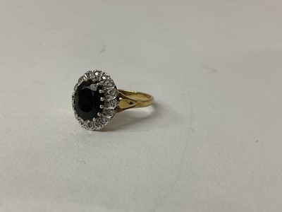 Lot 98 - 9ct gold Sapphire and diamond cluster ring with an oval mixed cut dark blue sapphire surrounded by a border of single cut diamonds, ring size N.
