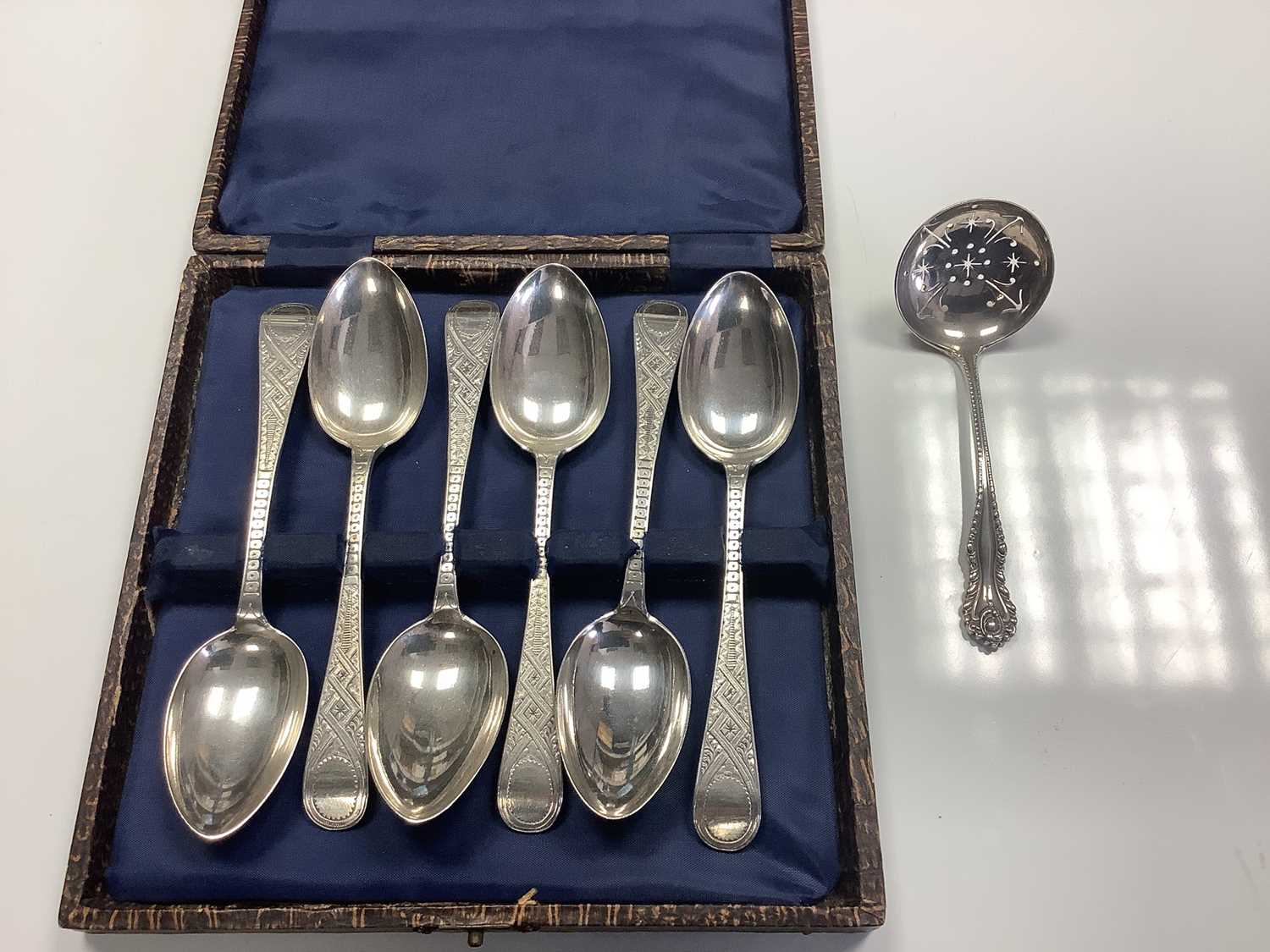 Lot 113 - Six Victorian Scottish silver Old English pattern teaspoons with engraved decoration (Glasgow 1879) in an associated fitted case, together a Victorian silver sifter spoon (London 1895), all at 4.5ozs