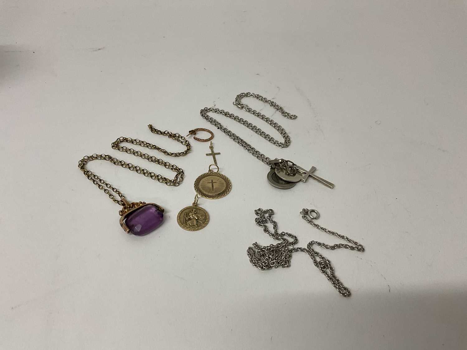 Lot 74 - Group 9ct gold and other jewellery to include a 9ct St Christopher pendant, another 9ct gold pendant, 9ct gold mounted revolving seal on yellow metal chain and two silver chains.