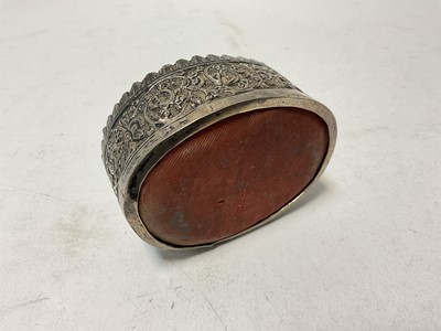 Lot 130 - 19th century Indian or Burmese white metal pin cushion of oval form, 9.2cm in length.