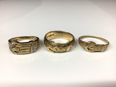 Lot 132 - 9ct gold diamond set buckle ring and two other 9ct gold buckle rings with embossed floral decoration (3)