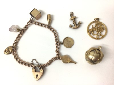 Lot 150 - 9ct rose gold charm bracelet with padlock clasp and six charms, plus three loose