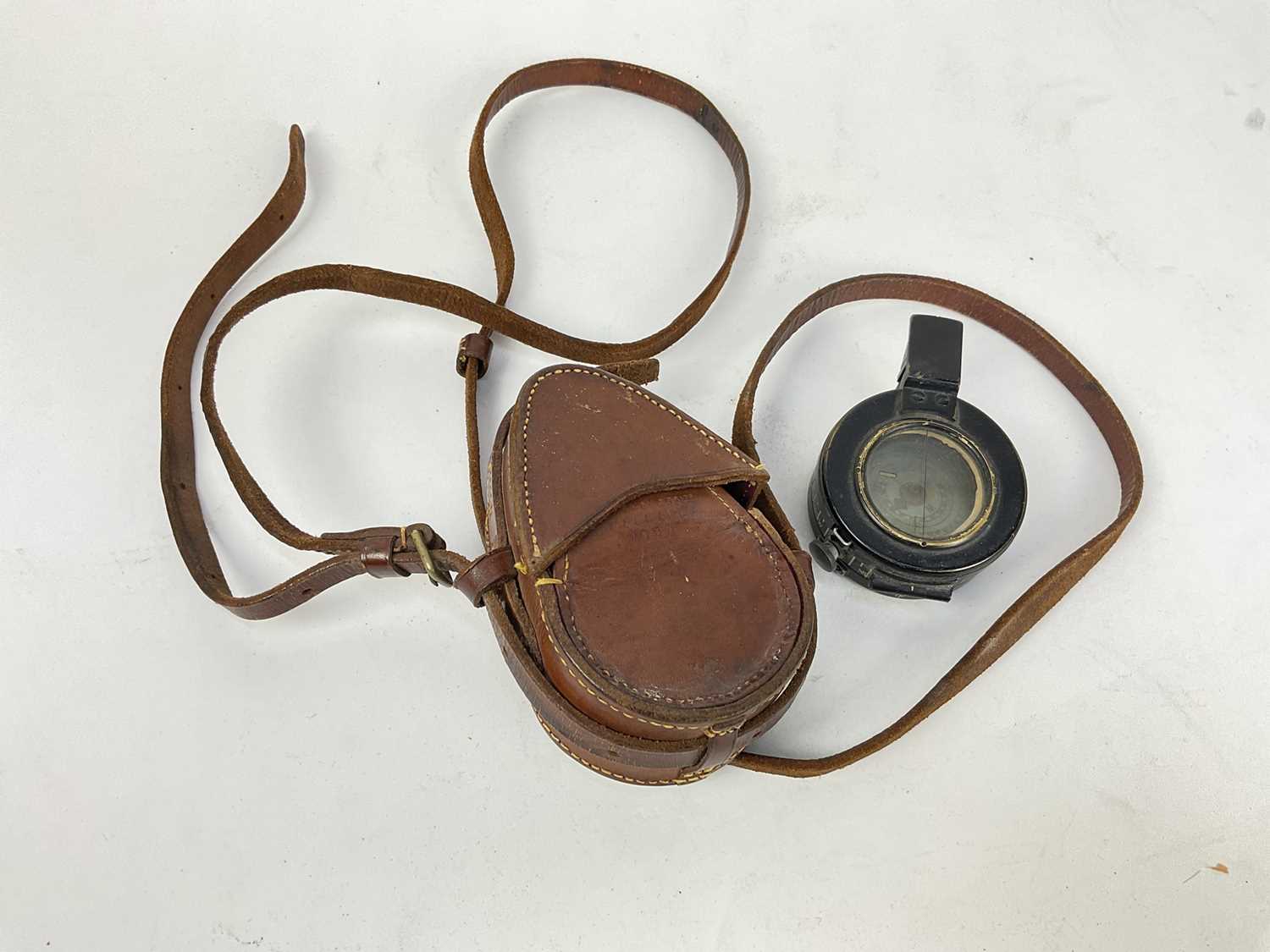 Lot 485 - Second World War British Military Officer's Prismatic compass, stamped T.G. Co. Ltd, London, No. 56411, MKIII, 1940, in original brown leather case.