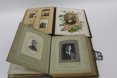 Lot 1402 - Early Photography - Two leather albums, one with illustrated pages, containing Victorian Cabinet cards, Carte de Visites and photographs, mainly family portraits, Cabinet card of Hagmater butcher's...
