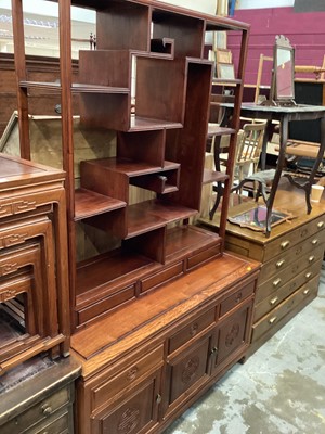 Lot 1056 - Chinese hardwood display stand on a stand with three drawers and cupboards below