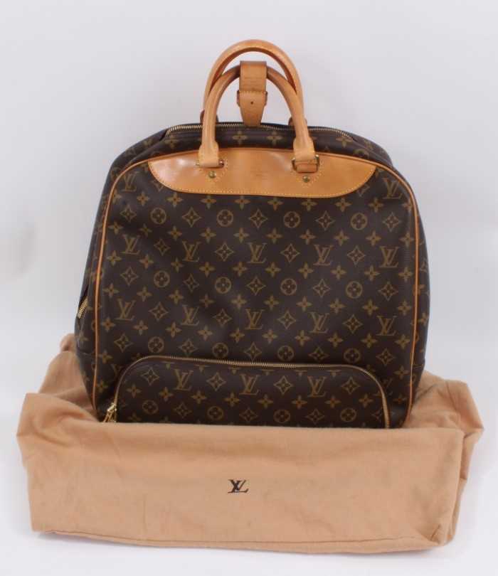 Lot 2090 - Louis Vuitton travel bag with signature monogrammed design and leather handles, together with a Louis Vuitton padlock and key, and. Versace umbrella