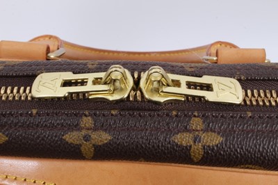 Lot 2090 - Louis Vuitton travel bag with signature monogrammed design and leather handles, together with a Louis Vuitton padlock and key, and. Versace umbrella