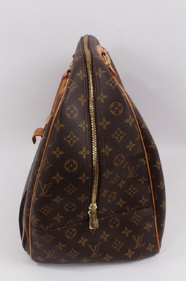 Lot 2090 - Louis Vuitton travel bag with signature monogrammed design and leather handles, together with a Louis Vuitton padlock and key, and. Versace umbrella