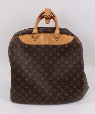 Lot 2090 - Louis Vuitton travel bag with signature monogrammed design and leather handles, together with a Louis Vuitton padlock and key, and. Versace umbrella