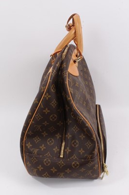 Lot 2090 - Louis Vuitton travel bag with signature monogrammed design and leather handles, together with a Louis Vuitton padlock and key, and. Versace umbrella