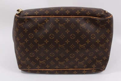 Lot 2090 - Louis Vuitton travel bag with signature monogrammed design and leather handles, together with a Louis Vuitton padlock and key, and. Versace umbrella