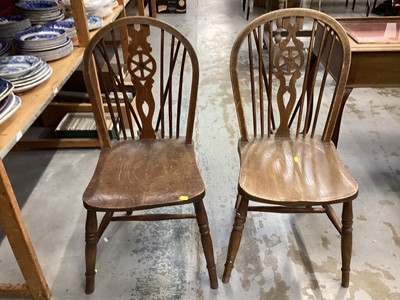 Lot 1043 - Set of four wheel back chairs together with an elbow chair with cane seat