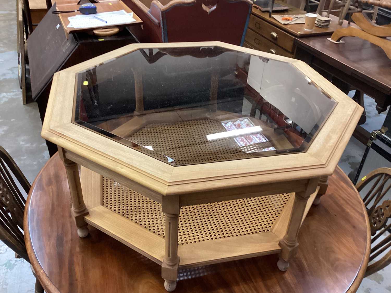 Lot 1044 - Octagonal coffee table with glass top on turned and block legs with caned undertier, 97cm wide, 43cm high