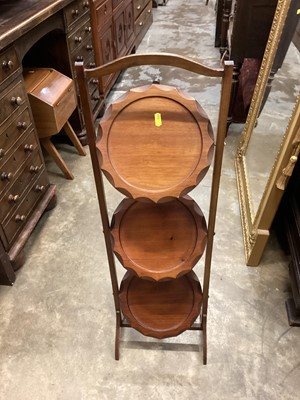 Lot 1049 - Three tier folding cake stand together with an oak occasional table with magazine rack undertier and a walnut sewing table