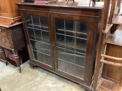 Lot 1050 - Edwardian mahogany bookcase with adjustable shelves enclosed by two leaded glazed doors on bracket feet, 121cm wide, 38cm deep, 119cm high