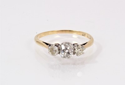 Lot 504 - Diamond three stone ring with a central cushion shape old cut diamond flanked by two old cut diamonds in platinum claw setting on 18ct gold shank