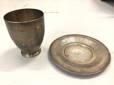 Lot 800 - White metal kiddish cup and dish, both with engraved Hebrew inscriptions and foliate decoration (stamped 84)