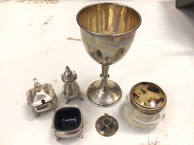 Lot 801 - 1920s silver goblet, 1960s silver three piece cruet set, silver topped glass vanity jar and a small silver figure (stamped 925 Israel)