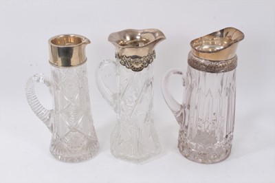 Lot 725 - Two silver mounted glass lemonade jugs and silver plated example